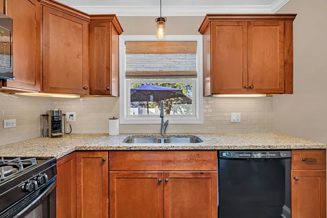 a kitchen with granite countertop cabinets and black appliances