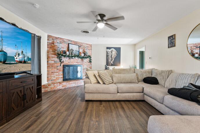 3008 68th Street Lubbock, TX 79413 - Photo 4 of 12 a living room with furniture and a fireplace