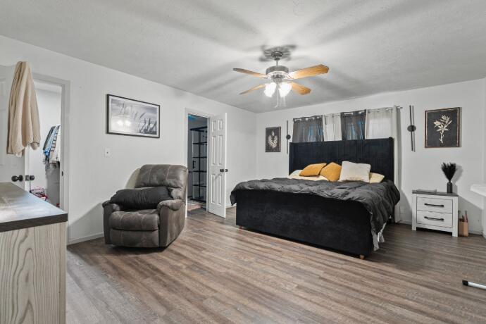 3008 68th Street Lubbock, TX 79413 - Photo 6 of 12 a bedroom with a bed and wooden floor