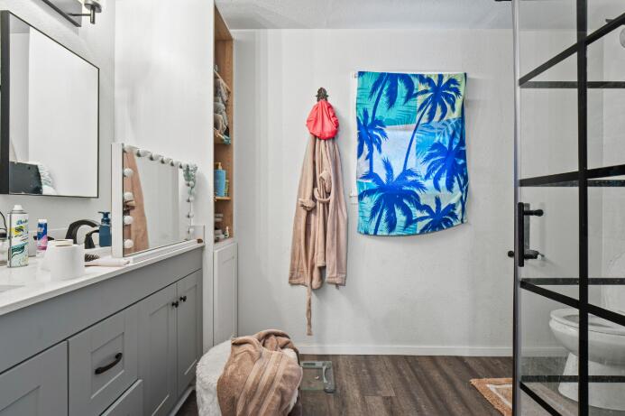 3008 68th Street Lubbock, TX 79413 - Photo 7 of 12 a bathroom with a sink a vanity and a mirror