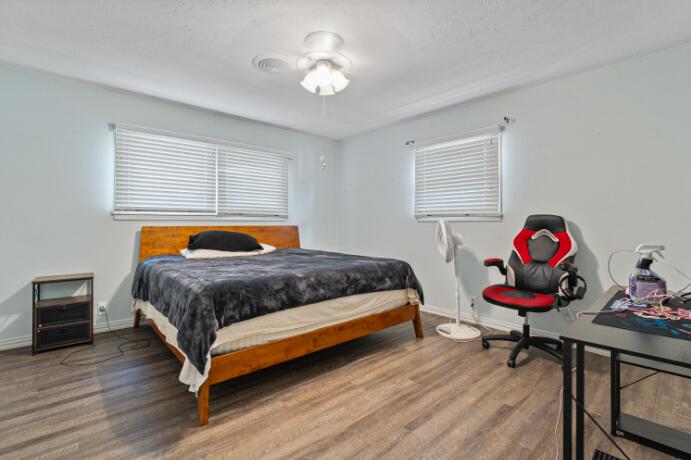 3008 68th Street Lubbock, TX 79413 - Photo 8 of 12 a bedroom with a bed and wooden floor