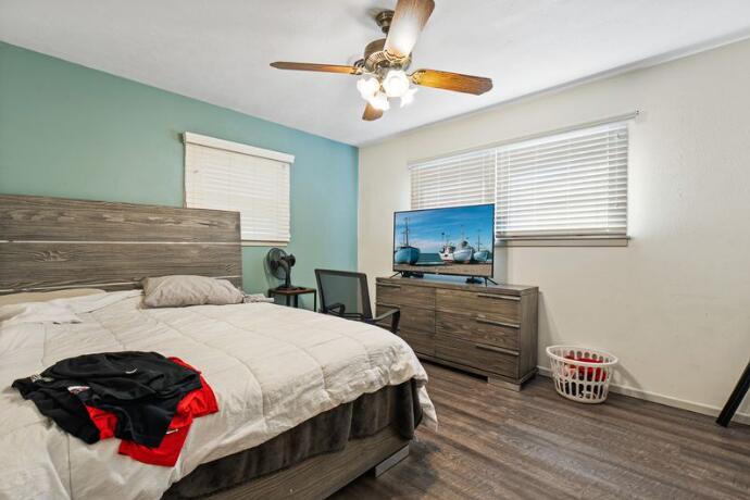 3008 68th Street Lubbock, TX 79413 - Photo 10 of 12 a bedroom with a bed and wooden floor