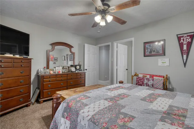 a bedroom with a bed and a dresser