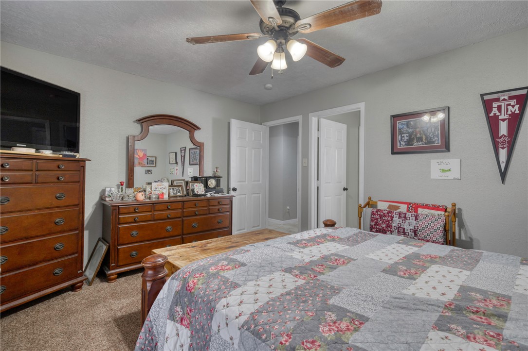 3501 Midwest Drive Bryan, TX 77802 - Photo 19 of 31 a bedroom with a bed and a dresser
