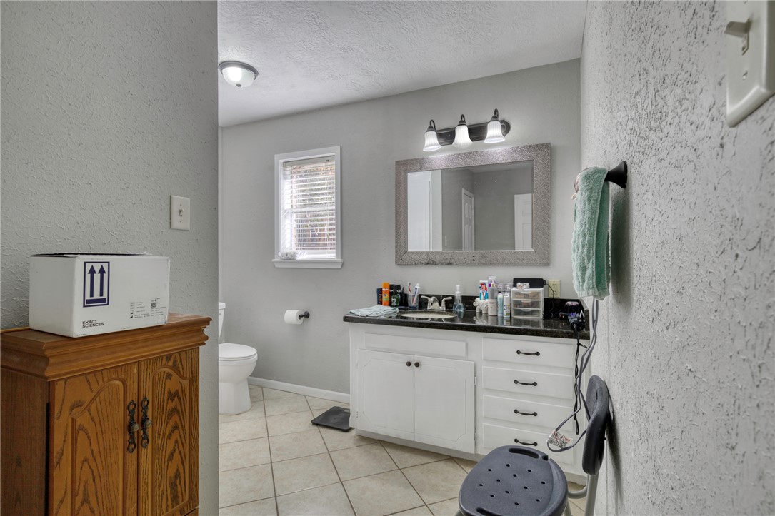 3501 Midwest Drive Bryan, TX 77802 - Photo 20 of 31 a bathroom with a sink a vanity and a mirror