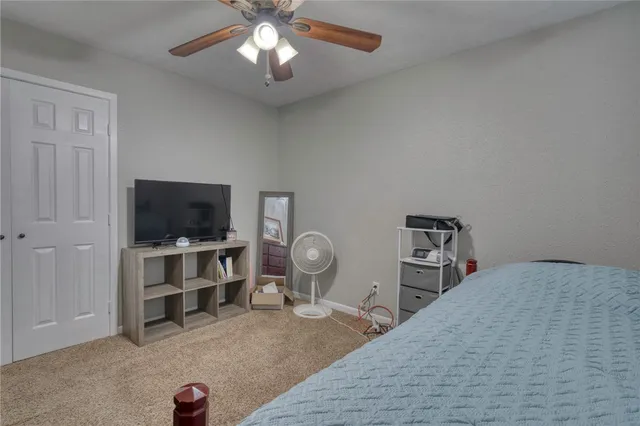 a bedroom with furniture and a flat screen tv