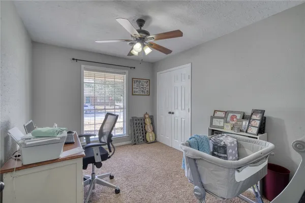 a living room with furniture and a ceiling fan