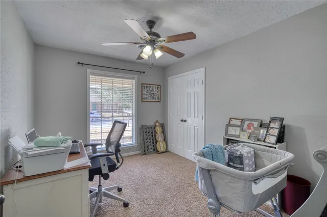 a living room with furniture and a ceiling fan