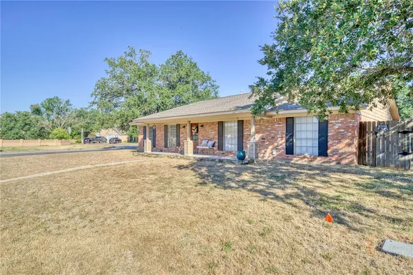 front view of a house with a large yard