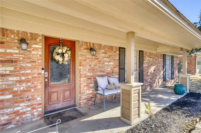 a living room with a fireplace furniture and a floor to ceiling window