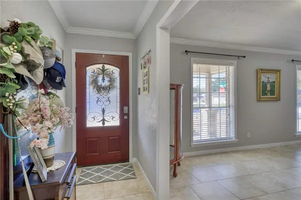 an entryway with a flower pot and a window