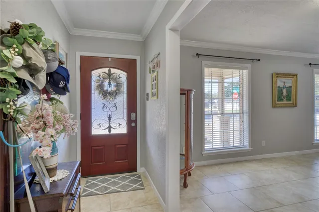 an entryway with a flower pot and a window