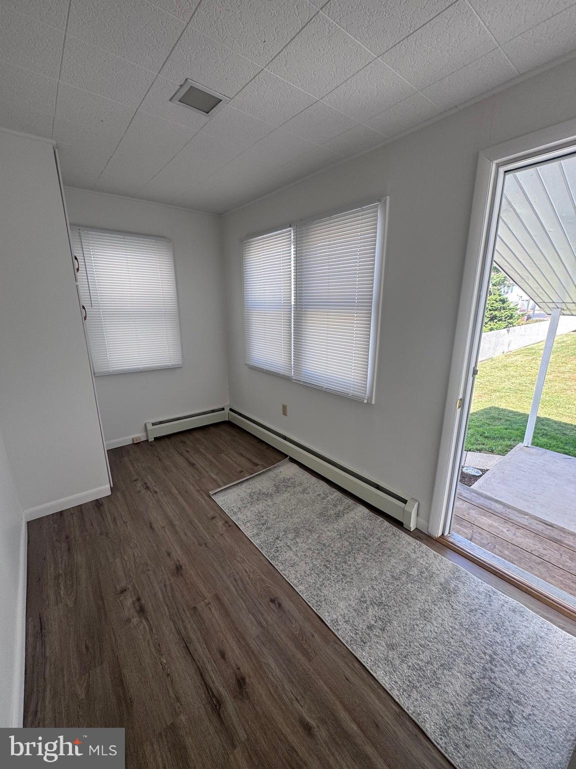 222 Armstrong Street Halifax, PA 17032 - Photo 3 of 18 an empty room with wooden floor and windows