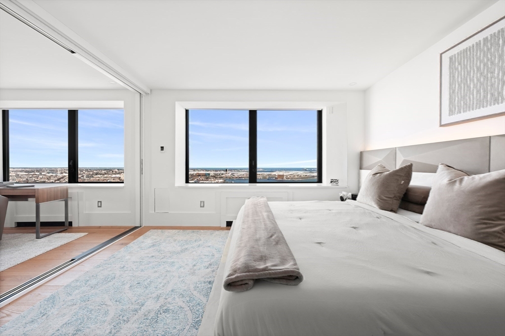 85 East India Row, Unit PHAB Boston, MA 02110 - Photo 12 of 42 a bedroom with a bed and large window