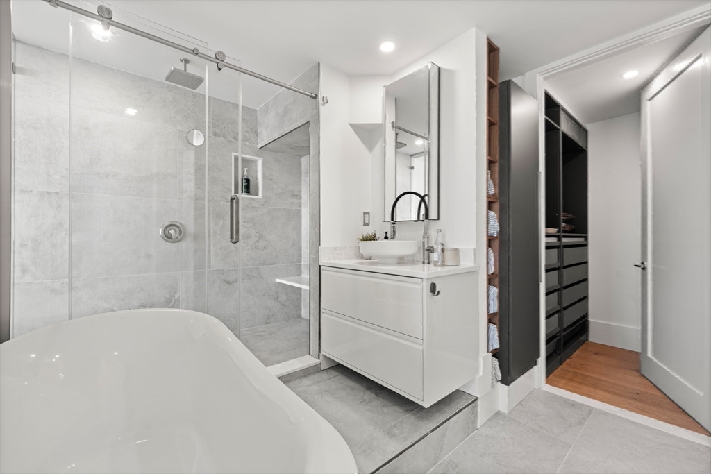 85 East India Row, Unit PHAB Boston, MA 02110 - Photo 13 of 42 a bathroom with a sink a toilet and shower