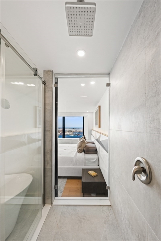 85 East India Row, Unit PHAB Boston, MA 02110 - Photo 14 of 42 a bathroom with a tub and a shower