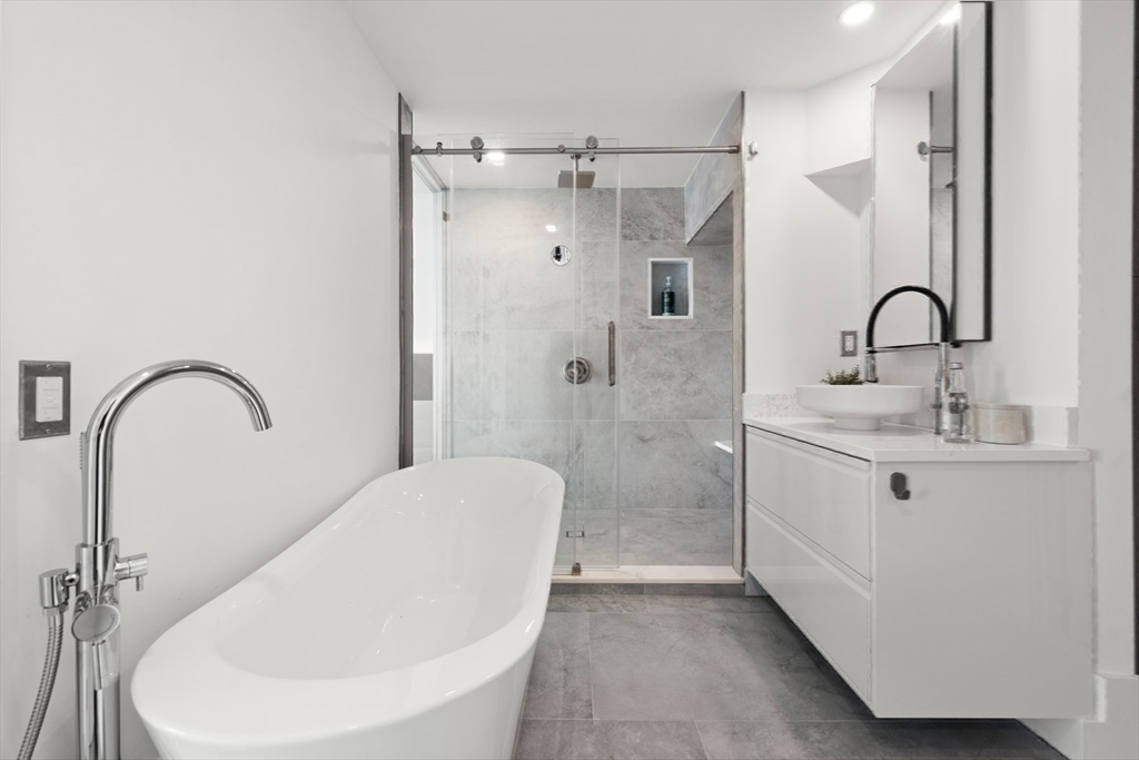 85 East India Row, Unit PHAB Boston, MA 02110 - Photo 15 of 42 a bathroom with a sink a toilet and shower