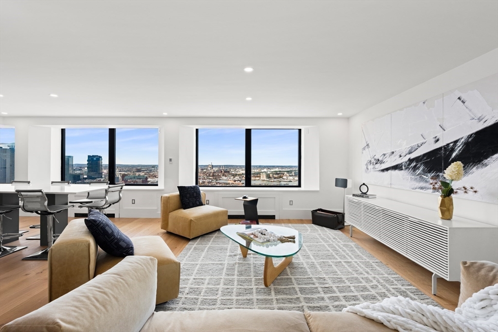 85 East India Row, Unit PHAB Boston, MA 02110 - Photo 17 of 42 a living room with furniture and a large window