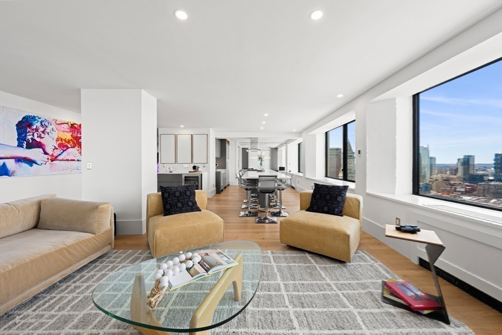 85 East India Row, Unit PHAB Boston, MA 02110 - Photo 18 of 42 a living room with furniture and a large window