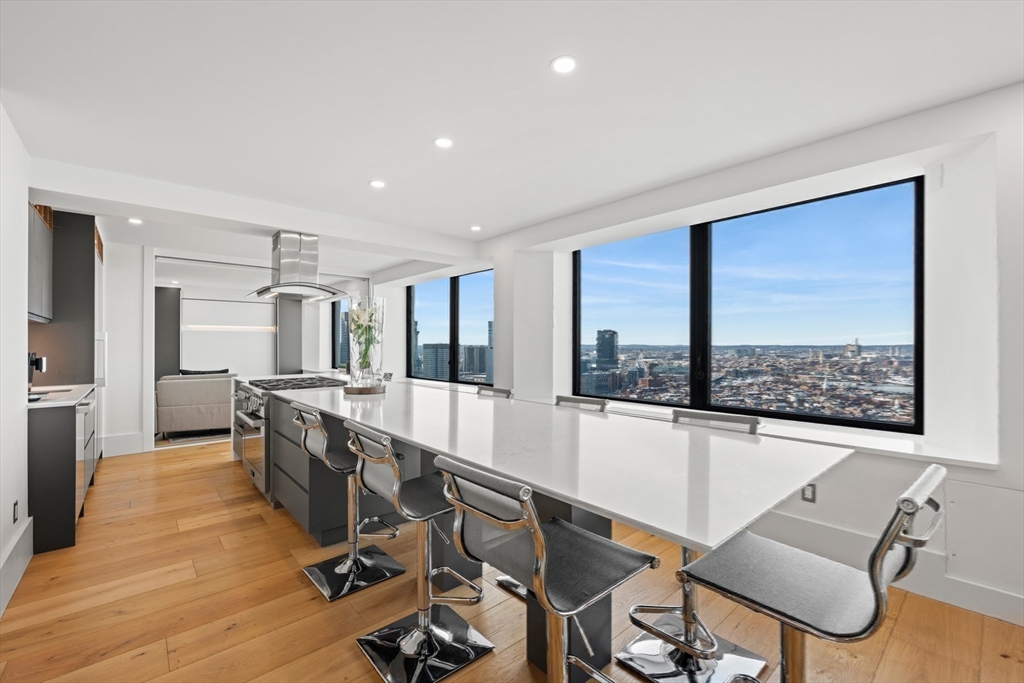 85 East India Row, Unit PHAB Boston, MA 02110 - Photo 19 of 42 a view of a dining room with furniture window and wooden floor