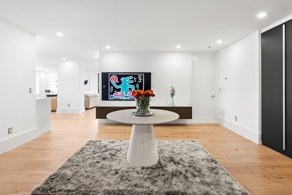 85 East India Row, Unit PHAB Boston, MA 02110 - Photo 2 of 42 a living room with stainless steel appliances furniture and a rug
