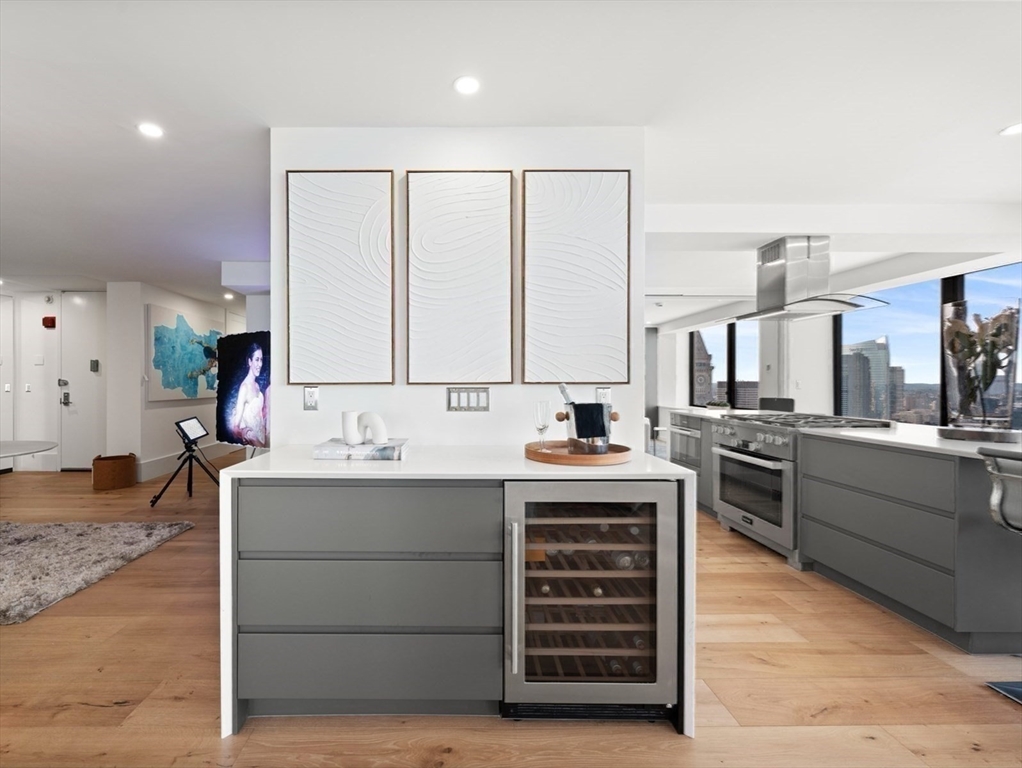 85 East India Row, Unit PHAB Boston, MA 02110 - Photo 23 of 42 a kitchen with stainless steel appliances a sink stove and cabinets