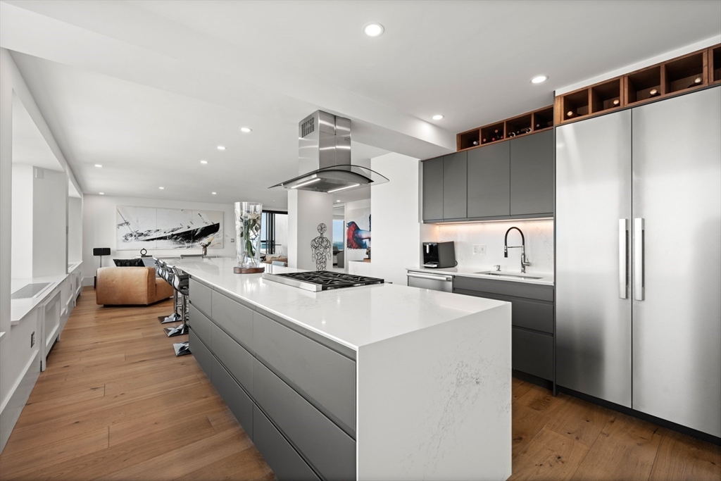 85 East India Row, Unit PHAB Boston, MA 02110 - Photo 24 of 42 a kitchen with stainless steel appliances a refrigerator a sink dishwasher and a stove top oven