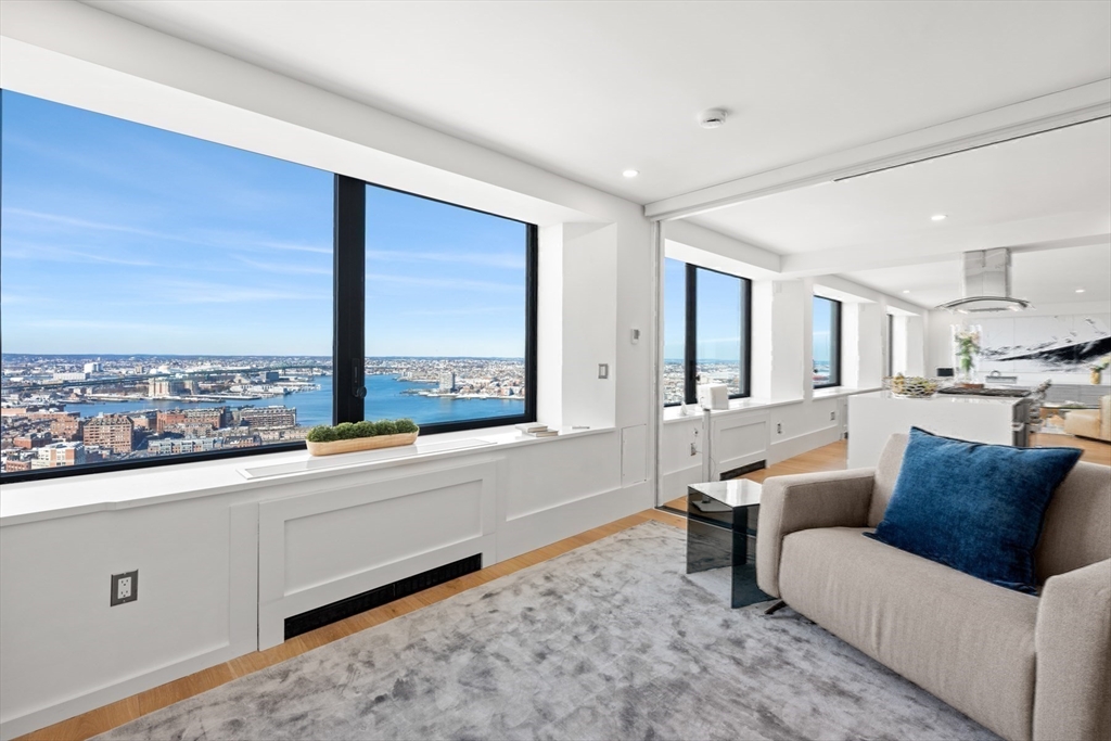 85 East India Row, Unit PHAB Boston, MA 02110 - Photo 29 of 42 a living room with furniture and a large window