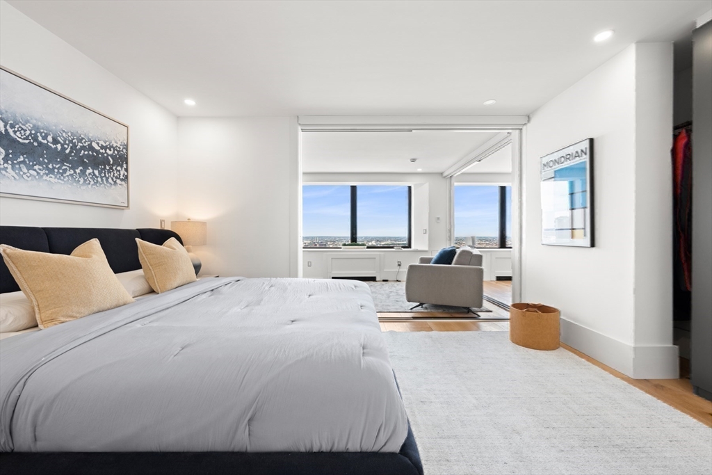 85 East India Row, Unit PHAB Boston, MA 02110 - Photo 32 of 42 a bedroom with a large bed and a large window