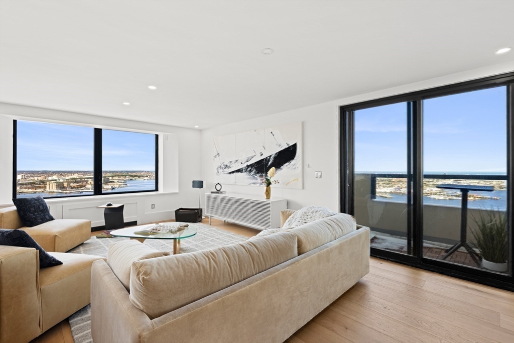 85 East India Row, Unit PHAB Boston, MA 02110 - Photo 35 of 42 a living room with furniture and a large window