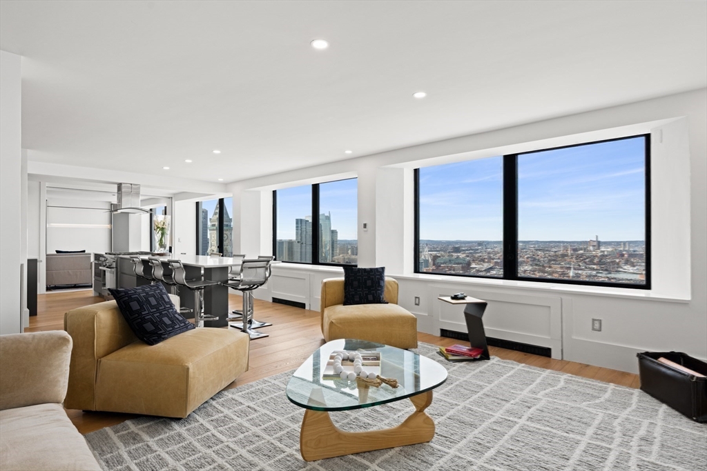 85 East India Row, Unit PHAB Boston, MA 02110 - Photo 5 of 42 a living room with furniture and a large window