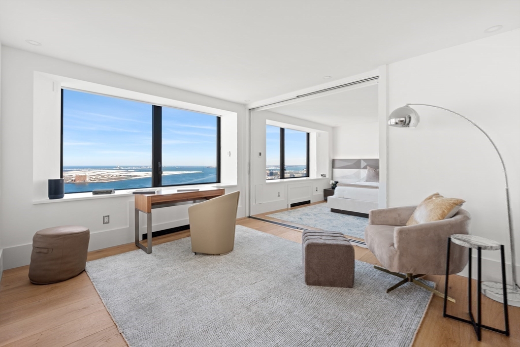 85 East India Row, Unit PHAB Boston, MA 02110 - Photo 7 of 42 a living room with furniture and a large window