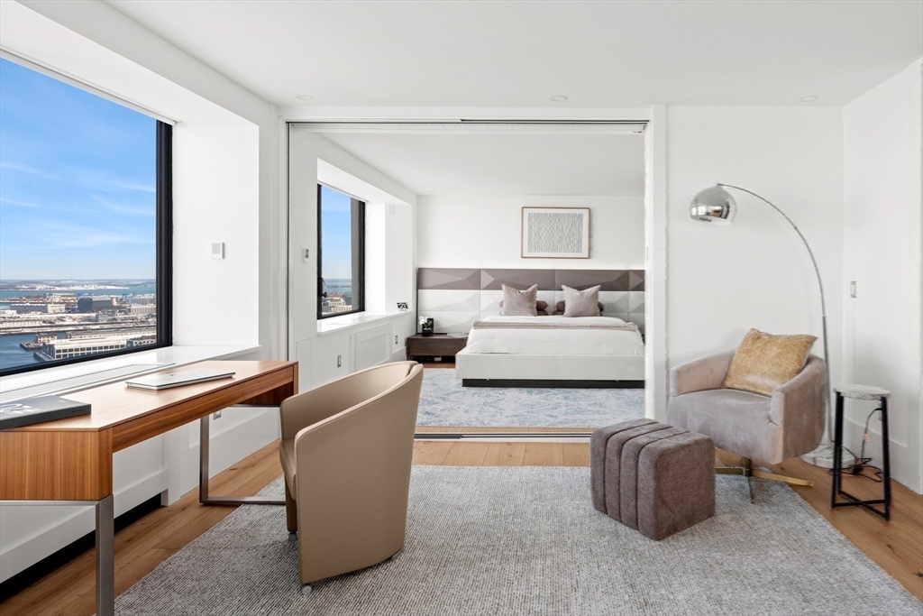 85 East India Row, Unit PHAB Boston, MA 02110 - Photo 8 of 42 a living room with furniture and a window