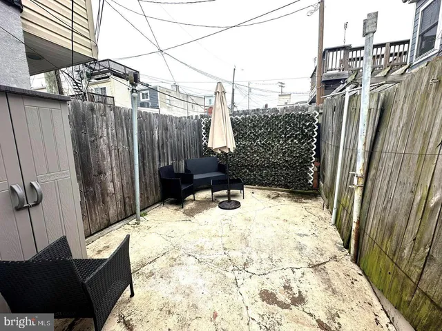 a picture of a bench in front of a wall