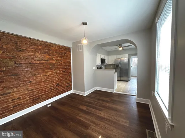 a kitchen with stainless steel appliances granite countertop a refrigerator a sink a stove and cabinets