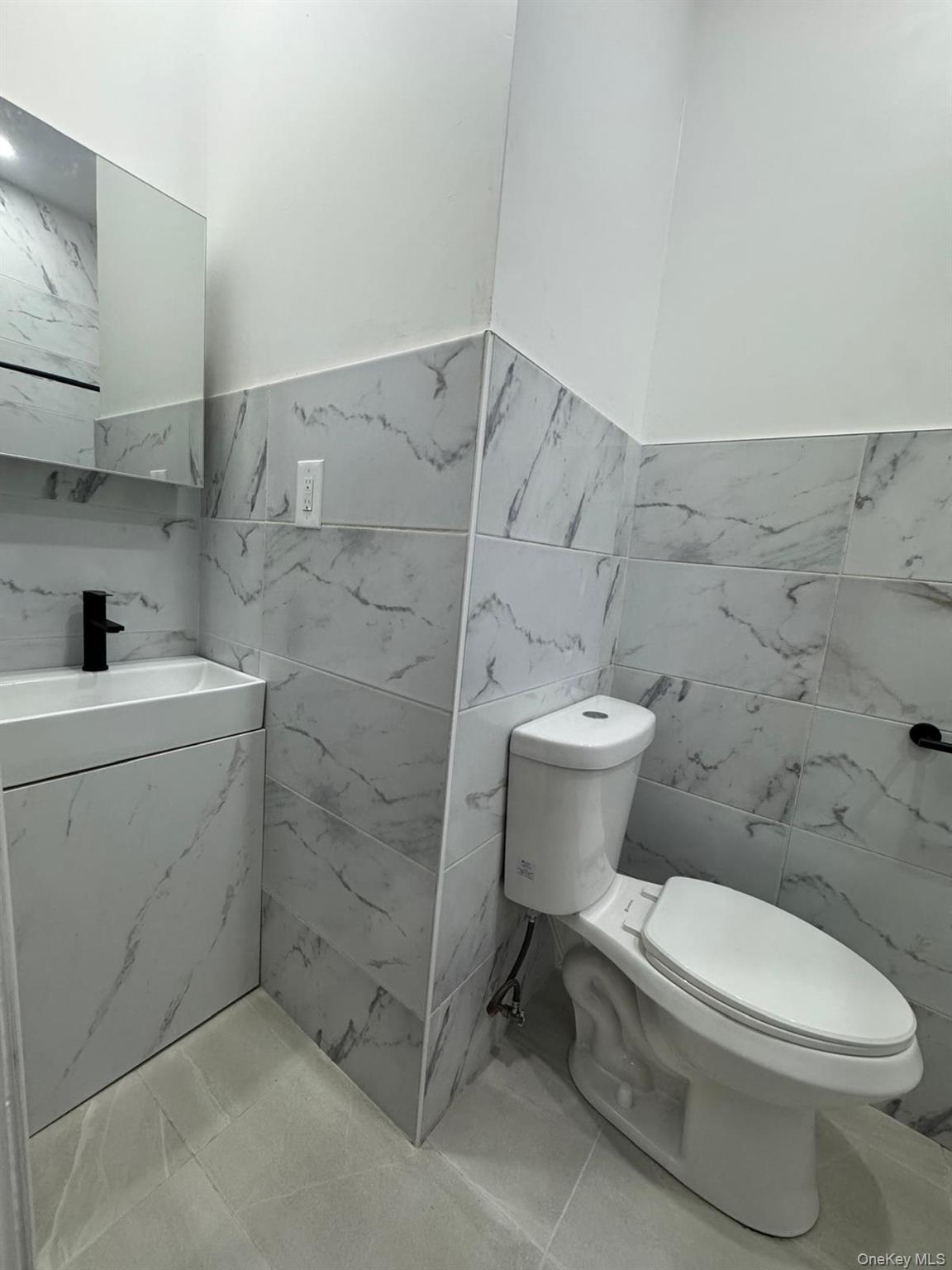168-11 88th Avenue Queens, NY 11432 - Photo 2 of 5 a bathroom with a toilet and a sink