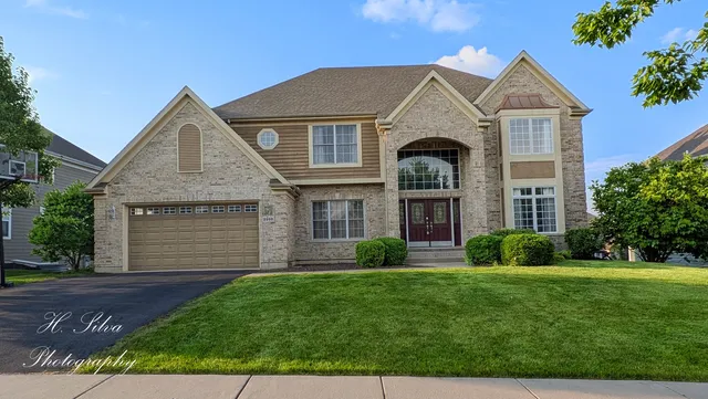 a front view of a house with a yard