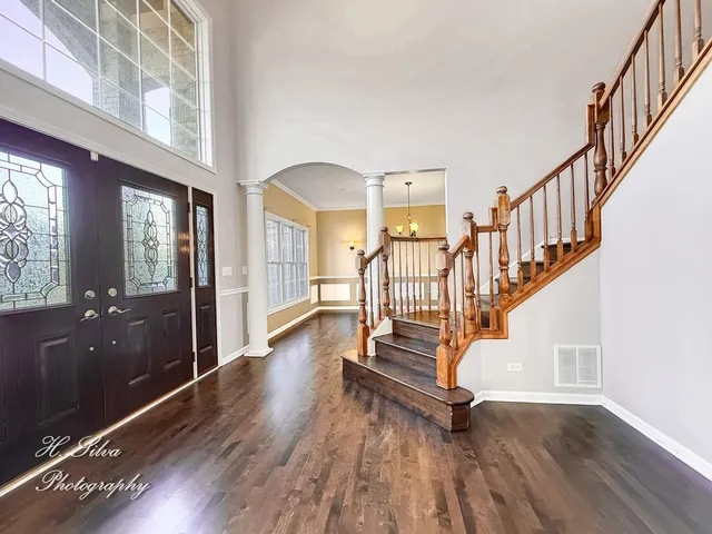 a view of entryway with wooden floor and stairs