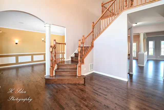 a view of entryway and hall with wooden floor