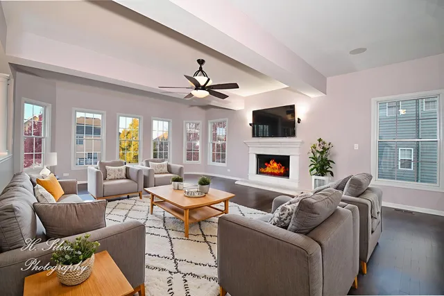 a living room with furniture a fireplace and a flat screen tv