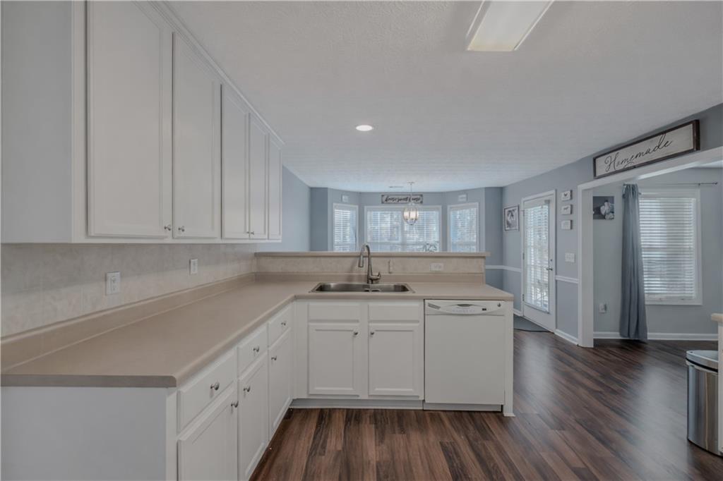 3100 Oak Ridge Lane Loganville, GA 30052 - Photo 11 of 43 a kitchen with a sink window and cabinets