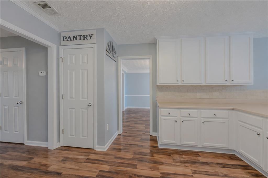 3100 Oak Ridge Lane Loganville, GA 30052 - Photo 12 of 43 a view of cabinets and wooden floor