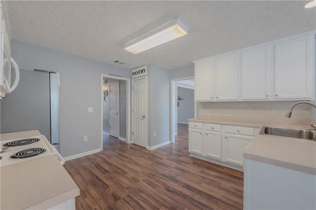 3100 Oak Ridge Lane Loganville, GA 30052 - Photo 13 of 43 a room with a bed and a view of kitchen