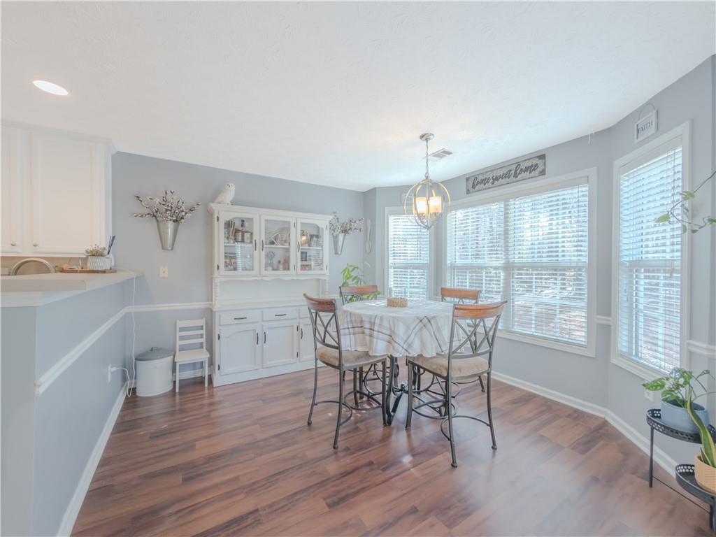 3100 Oak Ridge Lane Loganville, GA 30052 - Photo 15 of 43 a view of a dining room with furniture and wooden floor