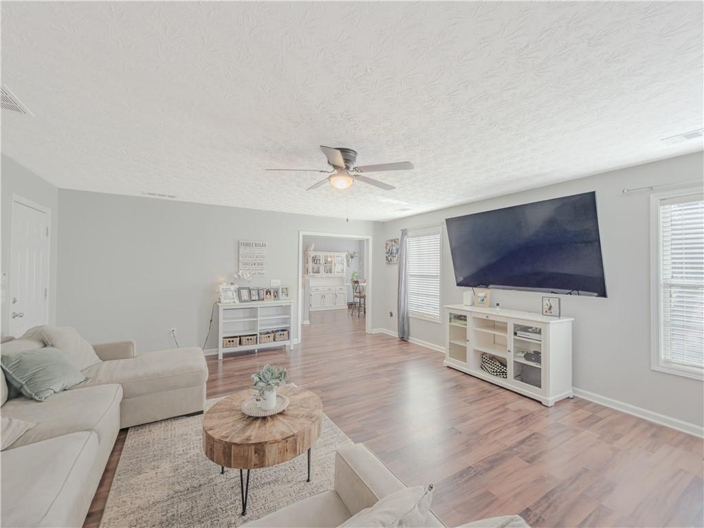 3100 Oak Ridge Lane Loganville, GA 30052 - Photo 18 of 43 a living room with furniture and a flat screen tv