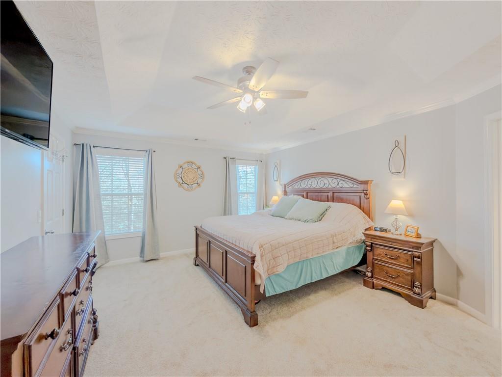 3100 Oak Ridge Lane Loganville, GA 30052 - Photo 20 of 43 a spacious bedroom with a bed and a chandelier