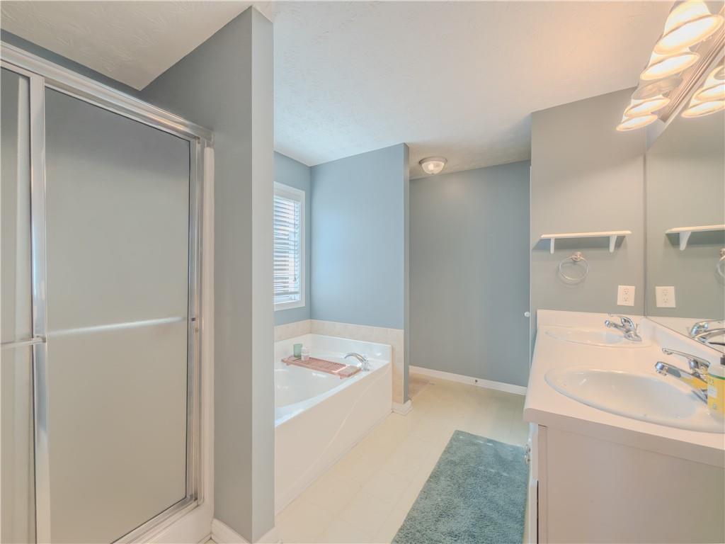 3100 Oak Ridge Lane Loganville, GA 30052 - Photo 22 of 43 a bathroom with a sink a bath tub and a shower