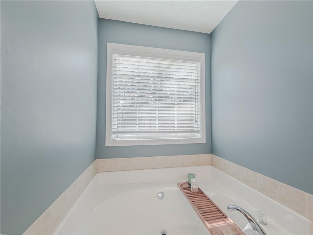 3100 Oak Ridge Lane Loganville, GA 30052 - Photo 23 of 43 a bathroom with a bathtub and a window