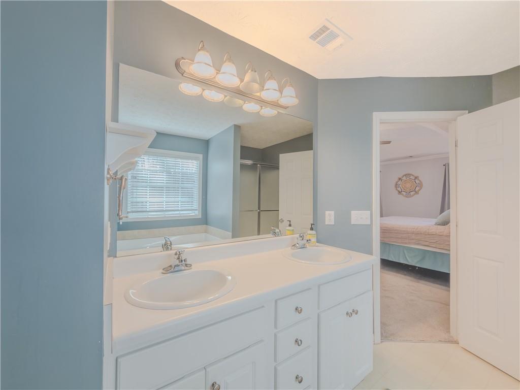 3100 Oak Ridge Lane Loganville, GA 30052 - Photo 25 of 43 a bathroom with a sink a double vanity and a mirror