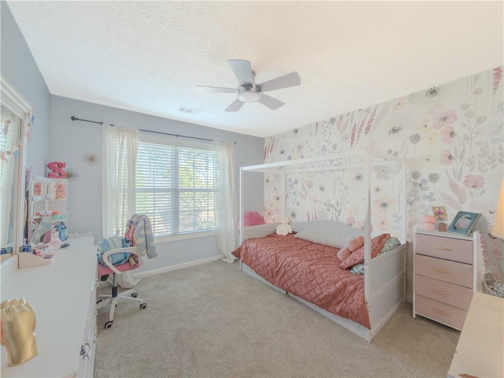 3100 Oak Ridge Lane Loganville, GA 30052 - Photo 26 of 43 a bedroom with a bed dresser and a window